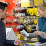 Smiling hardware store cashier assisting a customer at checkout, creating a positive shopping experience