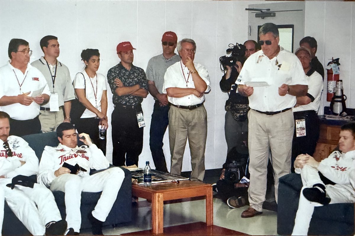 Drivers meeting participants reviewing race rules in a room